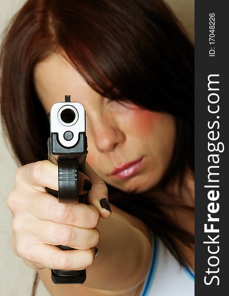 Young female pointing a gun
