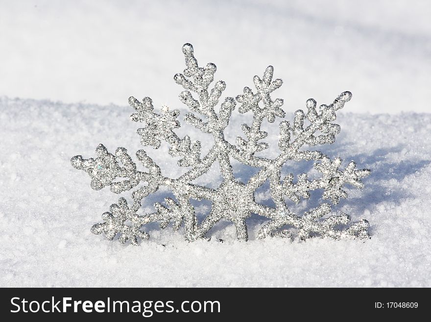 Beautiful silver snowflake in snow