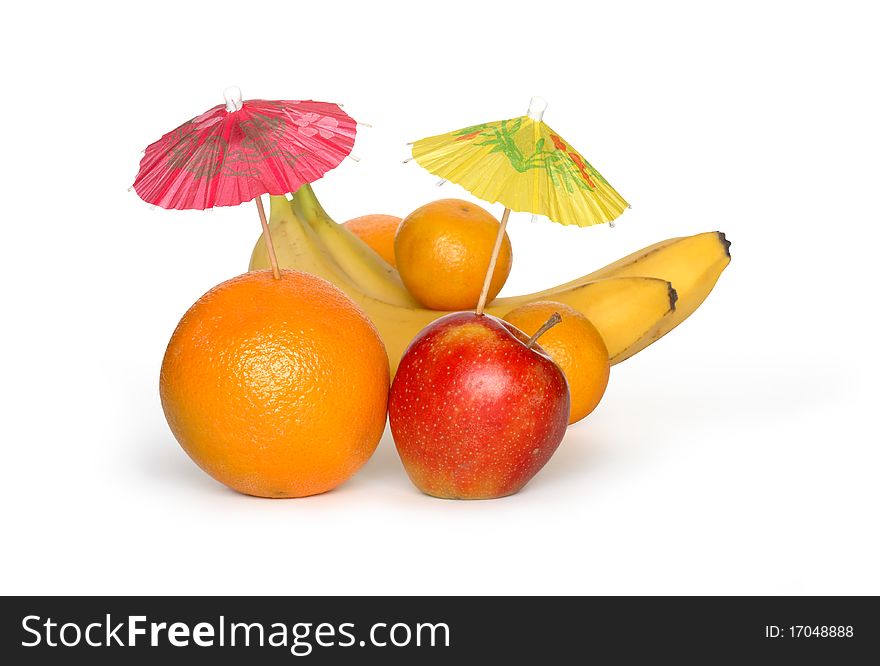 Orange and apple with small paper sunshades and other fruits on white background. Clipping path is included