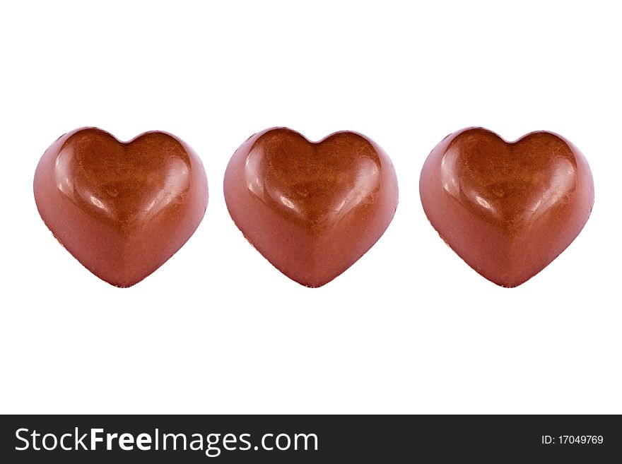 Three chocolate hearts, background, cake