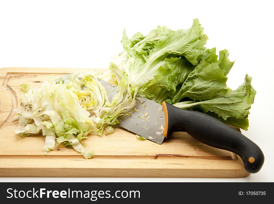Endives salad with knife and on edge board. Endives salad with knife and on edge board