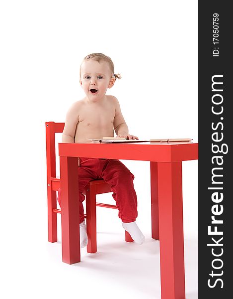 Baby girl is making fun sitting on the table. Baby girl is making fun sitting on the table