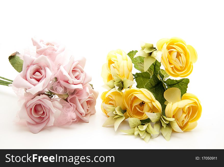 Pink and yellow bunch of roses onto white background