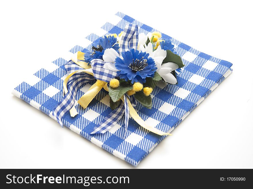 Blue flower jewelry onto blue-white table cloth