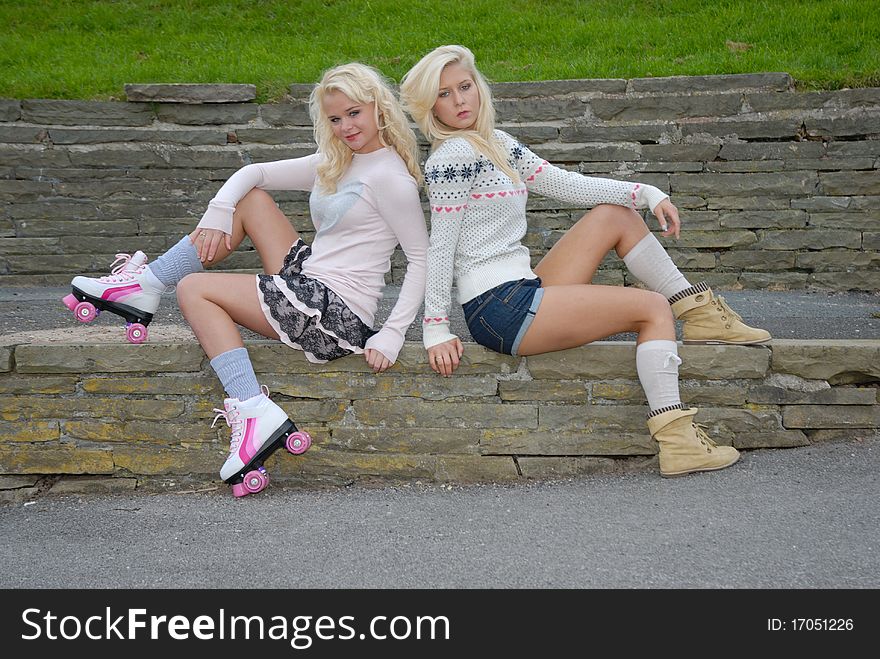 Photograph of two pretty young women on skates. Photograph of two pretty young women on skates