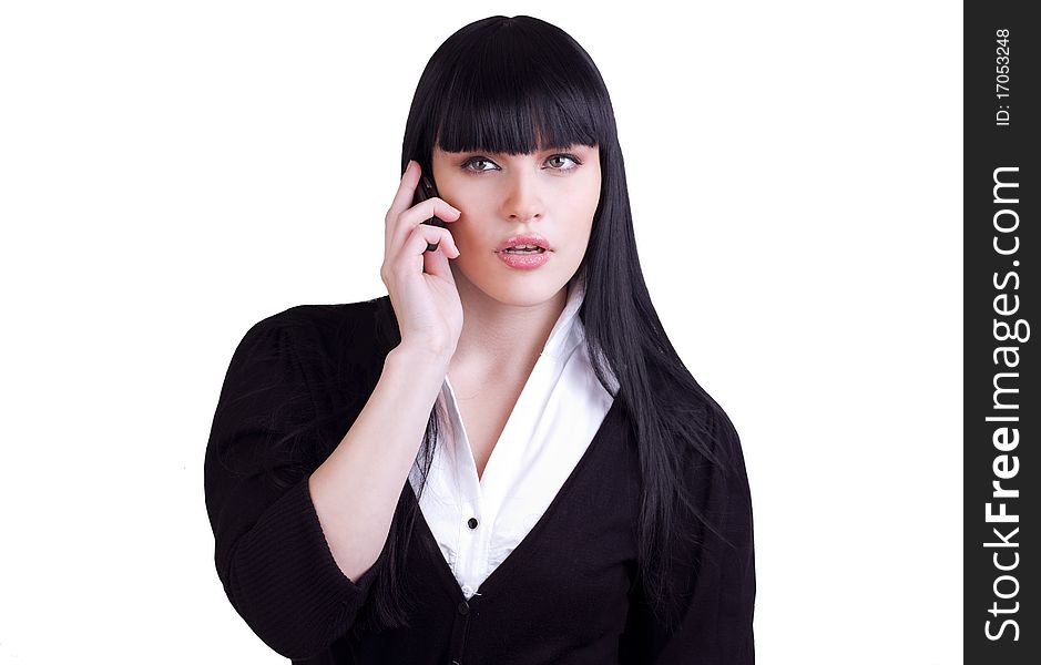 A young businesswoman surprises as she listens to someone talking on cell phone on white. A young businesswoman surprises as she listens to someone talking on cell phone on white