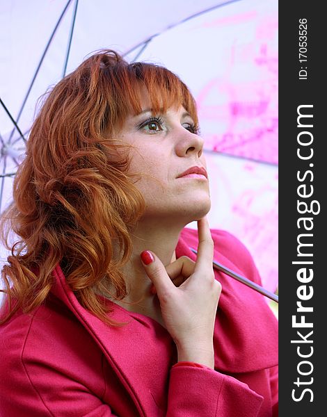 A young woman under a pink umbrella. A young woman under a pink umbrella