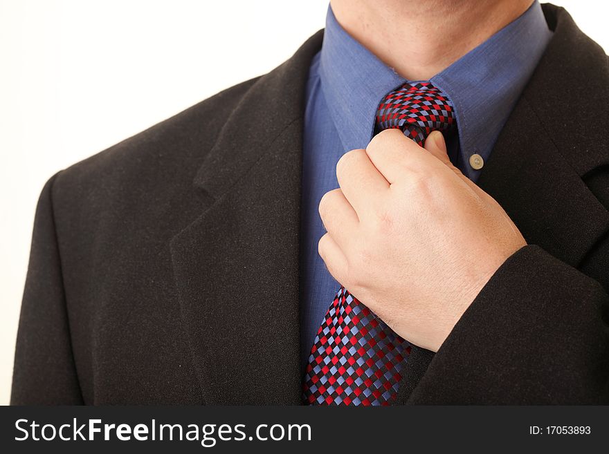 Businessman adjusting his tie blue