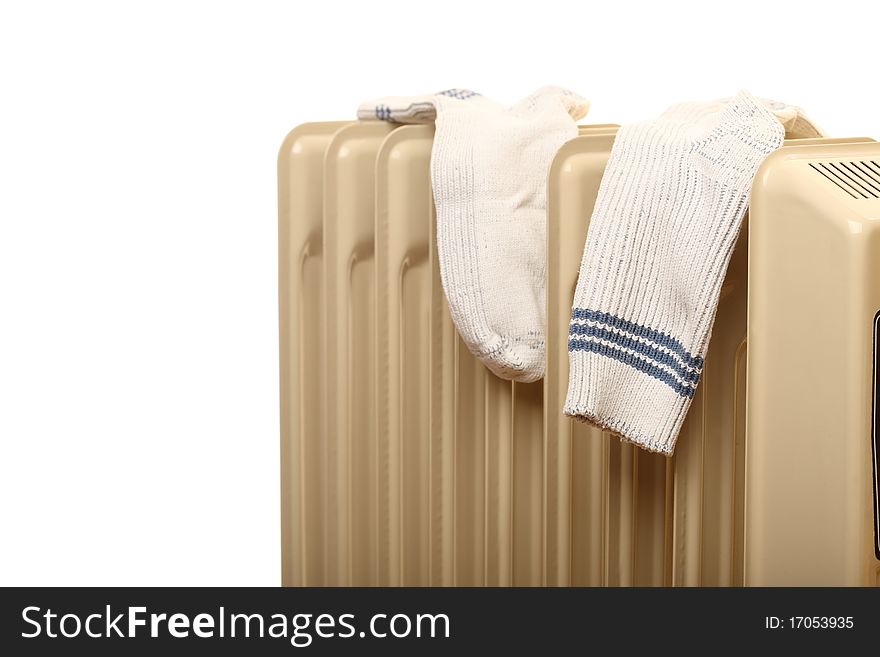 Oil radiator drying isolated pair of socks - Heatings on a white background. Oil radiator drying isolated pair of socks - Heatings on a white background