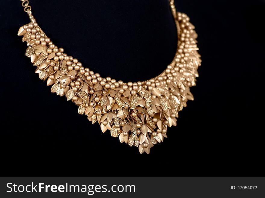 Luxurious gold India necklace close-up isolated over white. Luxurious gold India necklace close-up isolated over white