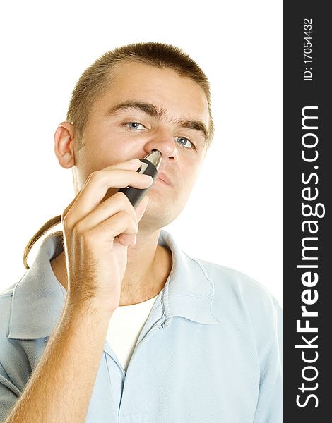 Young man with machine shaves off her hair in the nose. Isolated on a white background. Young man with machine shaves off her hair in the nose. Isolated on a white background