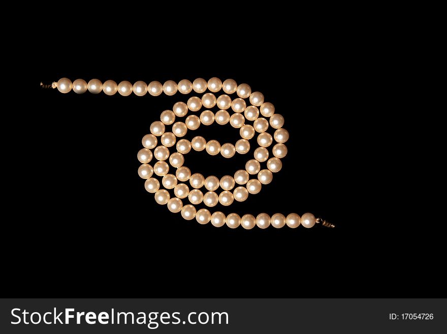 Studio photo of white pearls on black background