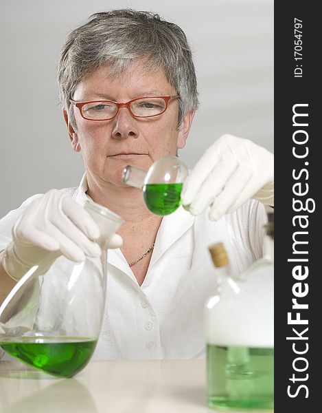 Scientist Is Working With A Green Liquid