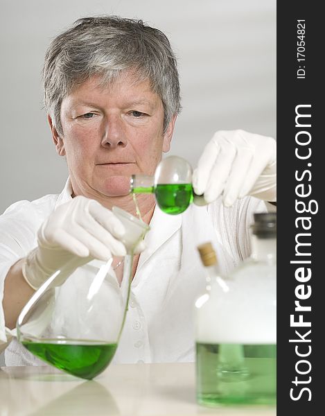 Scientist is working with a green liquid