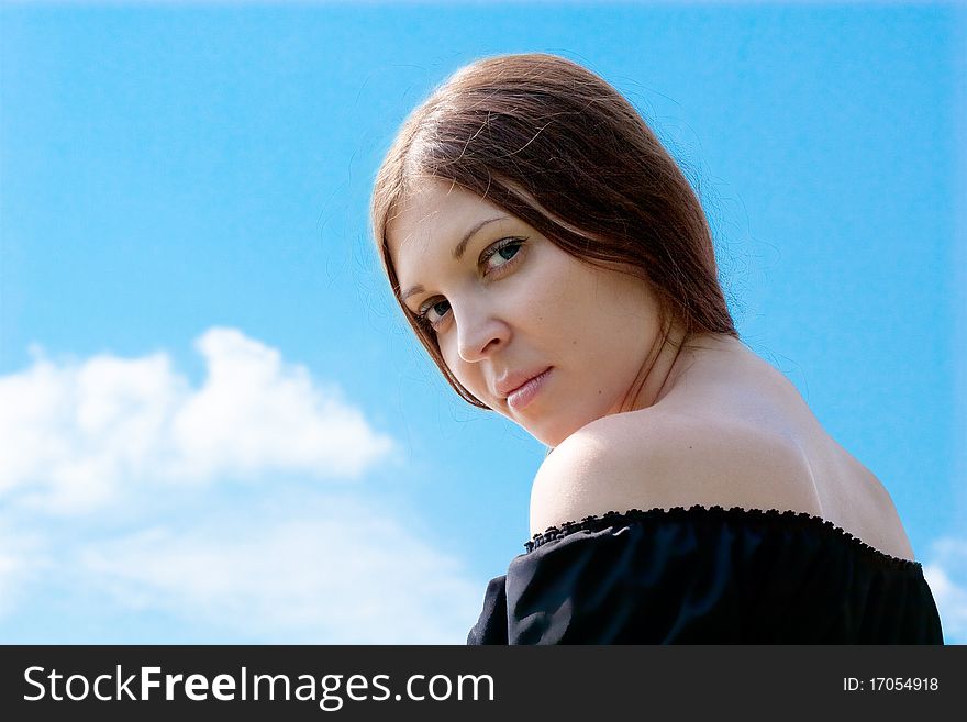 Pretty young woman and summer blue sky. Pretty young woman and summer blue sky