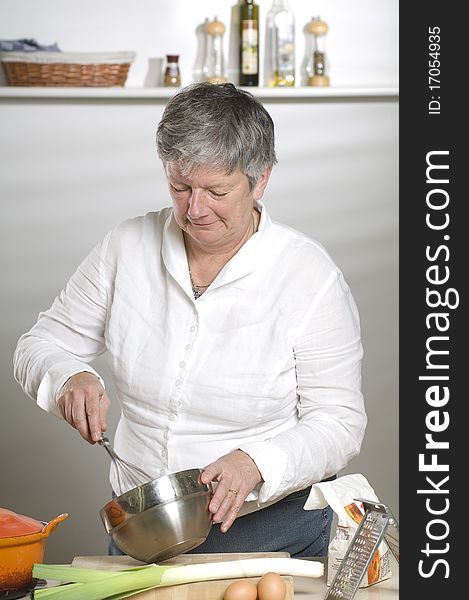 Women is using a mixer in the kitchen