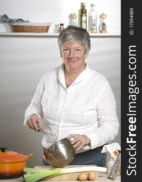 Women is using a mixer in the kitchen