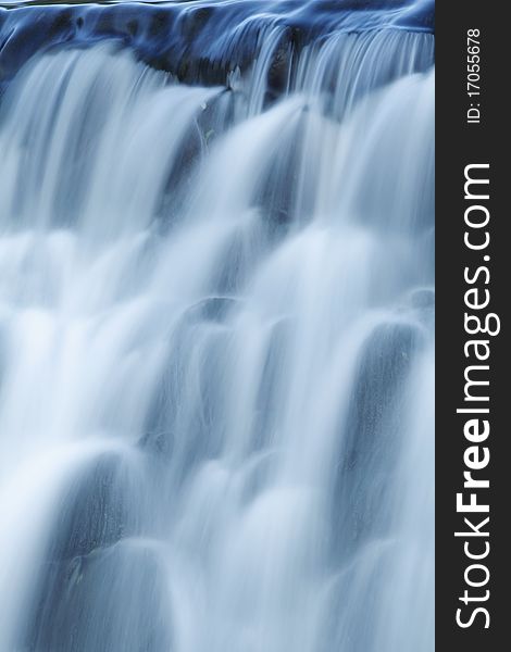 Waterfall on mountain river vertical photo