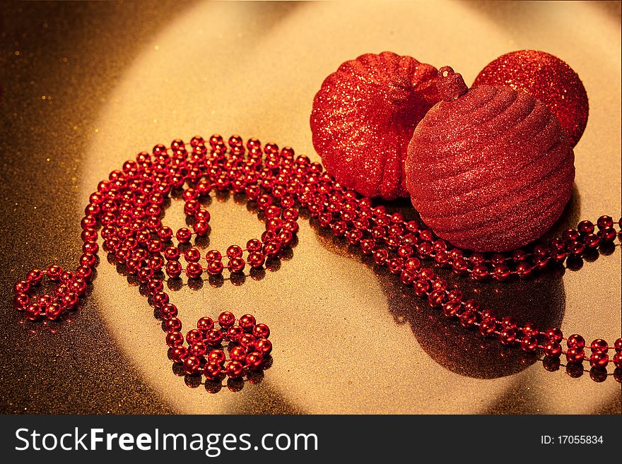 Red glitter Christmas baubles on golden glitter background - copy space. Red glitter Christmas baubles on golden glitter background - copy space