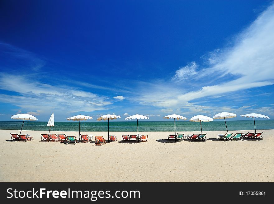 Beach chairs with umbrellas on a sunny day