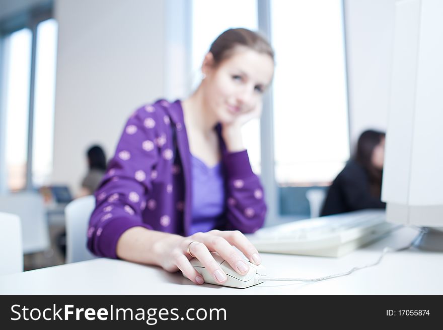 Pretty young college student in a library (shallow DOF; color toned image)