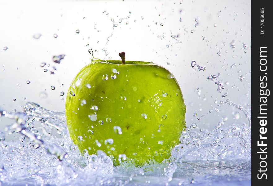 Fruits falling in water on white background