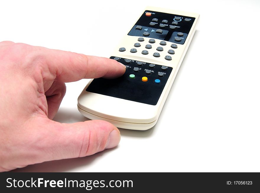 Human hand with TV remote control over white background