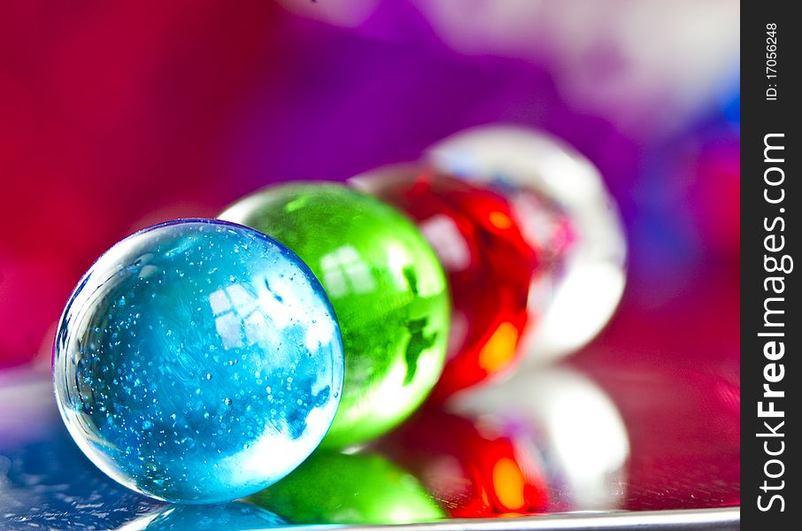 Marbles on colorfull blurred background