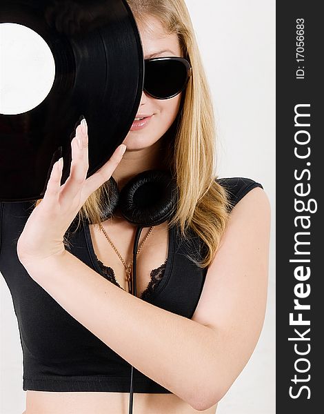 Blond girl in sunglasses and headphones posing. Blond girl in sunglasses and headphones posing