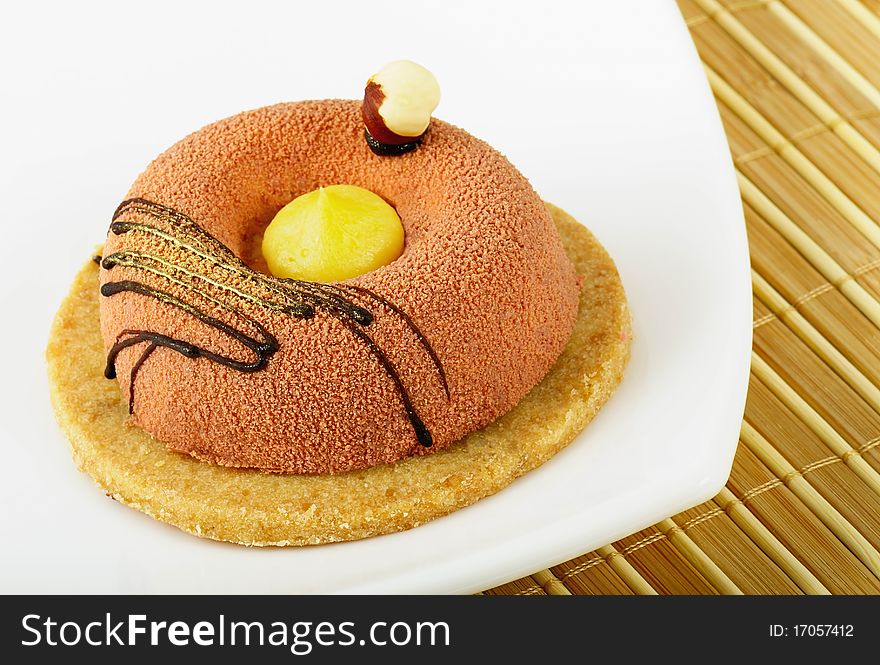 The cake lays on a white plate. Closeup. The cake lays on a white plate. Closeup