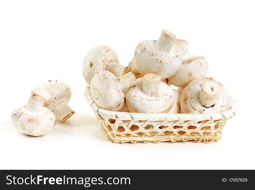 Mushrooms champignon in wooden basket