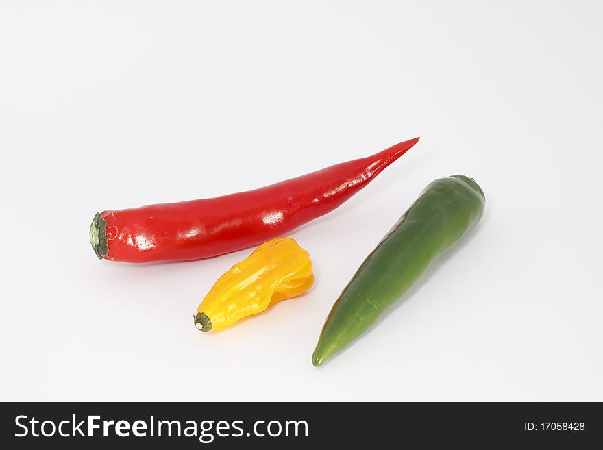 Studio shot, three chili peppers in front of white background. Studio shot, three chili peppers in front of white background