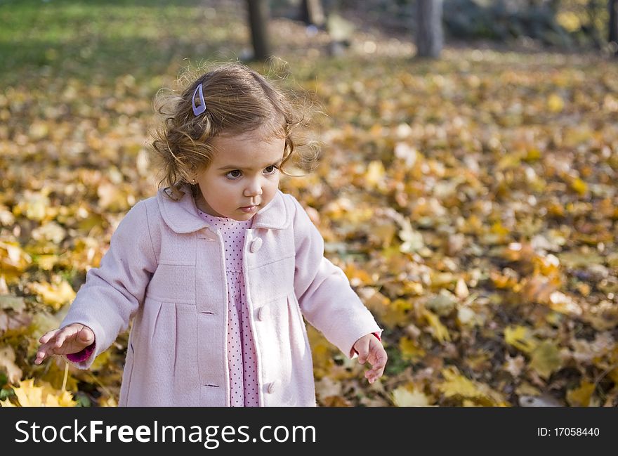 Portrait with curious little girl in autumn