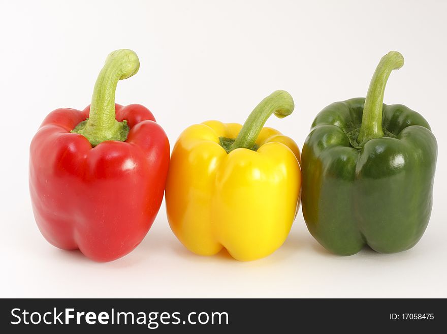 Studio shot, colored peppers in front of a white background