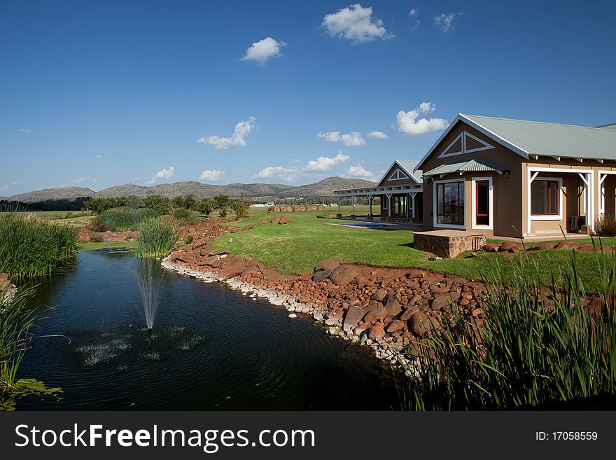 Home in lush coutryside by stream with fountain. Home in lush coutryside by stream with fountain