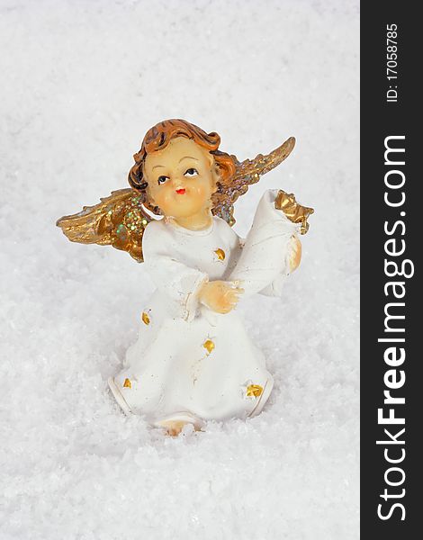 Little angel in artificial snow christmas decoration. Little angel in artificial snow christmas decoration