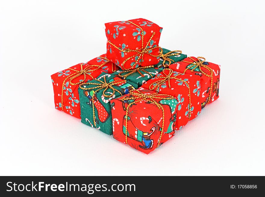 Stack of little decoration in form of gift boxes isolated on white