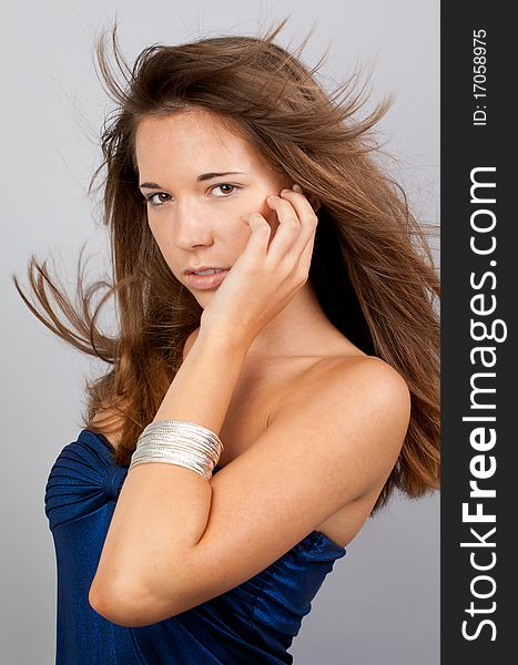 A fashion portrait of a gorgeous sixteen year old with windblown hair, gazing at the viewer. A fashion portrait of a gorgeous sixteen year old with windblown hair, gazing at the viewer