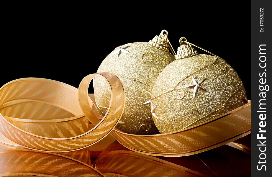 Two christmas balls with ribbon,black background