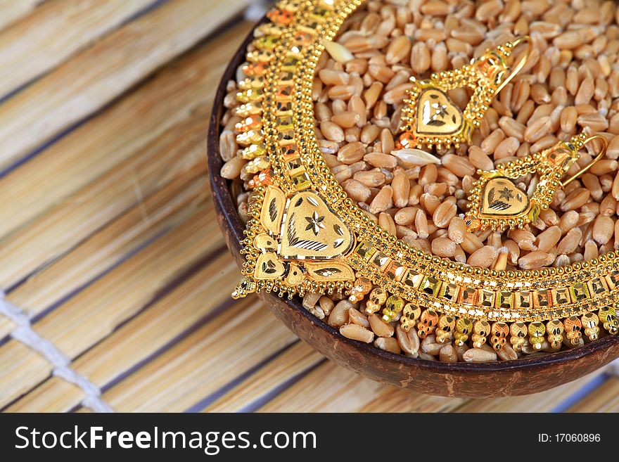 Concept shot of golden necklace and ear-rings jewellery.