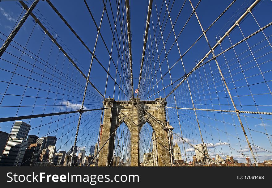 The Brooklyn Bridge with the Brooklyn skyline in the background.