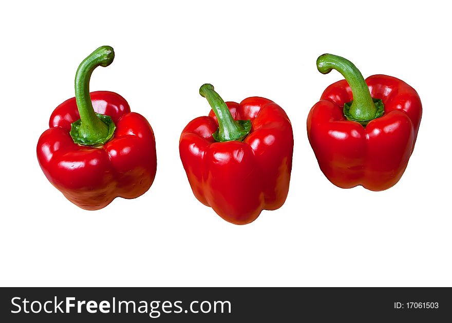 Three pods of red sweet pepper