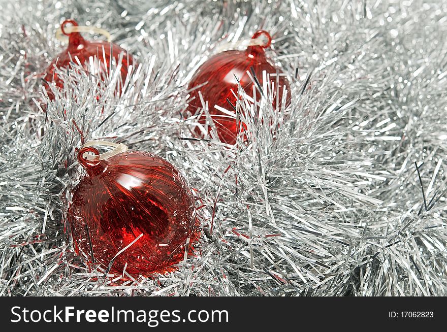 Red Glass Baubles On Silver Tinsel.