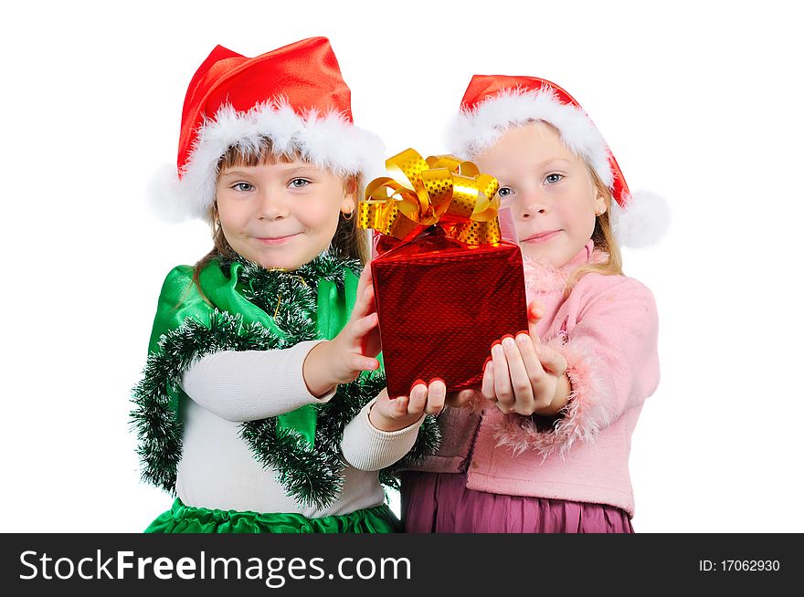 Two girls in the Christmas dress stretch a gift. Isolated on white