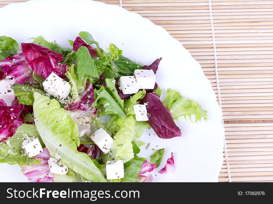 Salad With Leafs And Sheep Cheese On Plate
