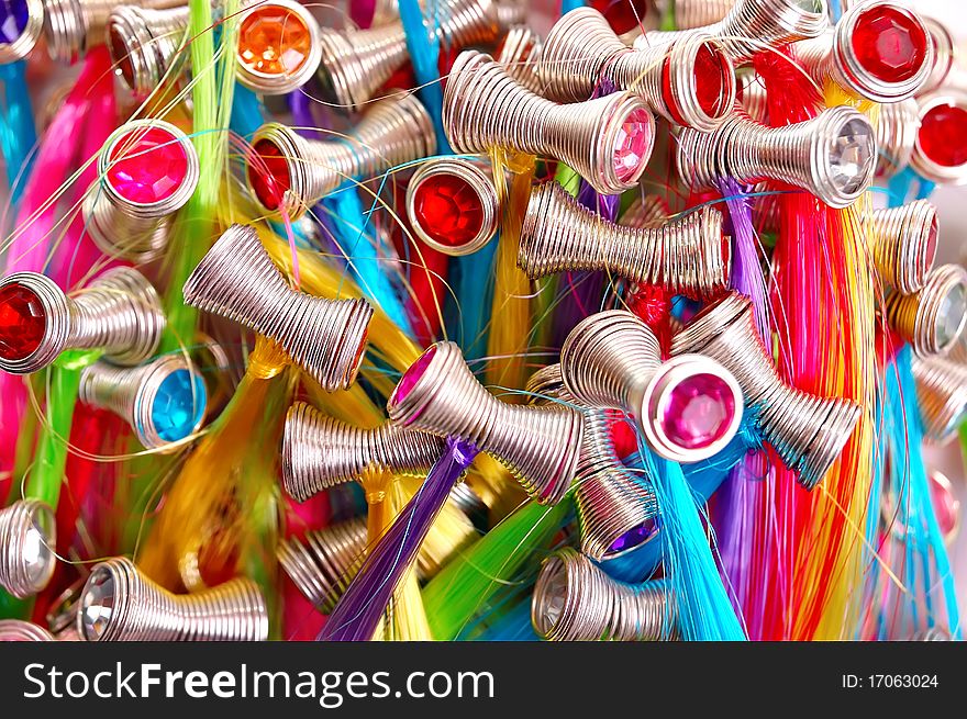 Multicolored background from hairpins in the form of a spring with artificial hair