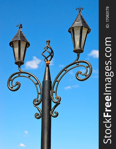 Street lantern against the blue sky. Vintage style