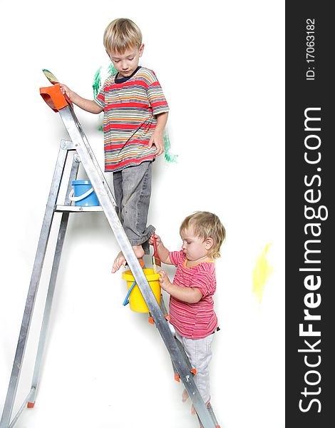 Two children painting over white