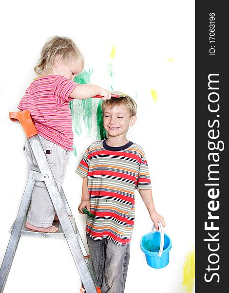 Two children painting over white