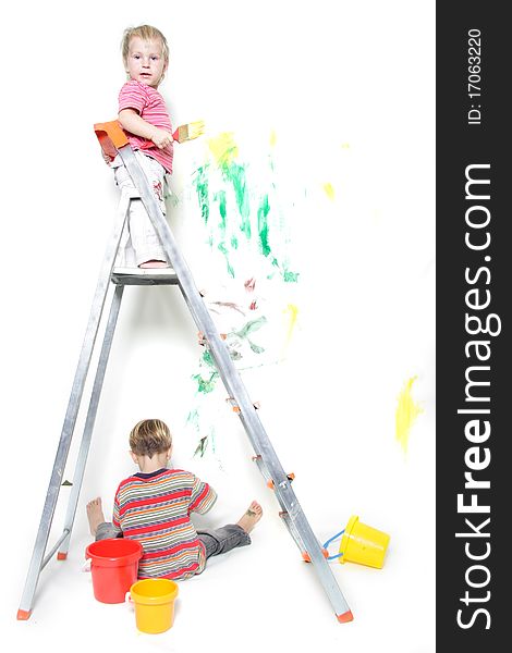 Two children painting over white